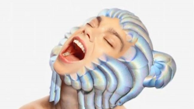 Bjork with a shell-like technological headpiece in the Hunter music video.